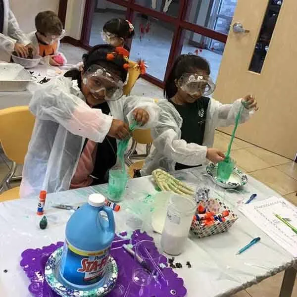 Primary level Montessori children working independently with learning materials in Allen, TX