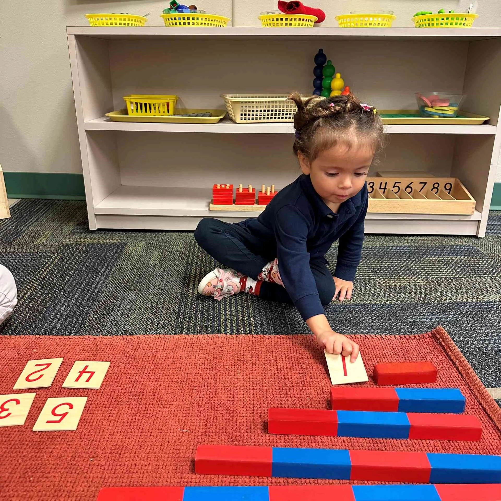 Child engaging with Montessori math materials in Allen, TX
