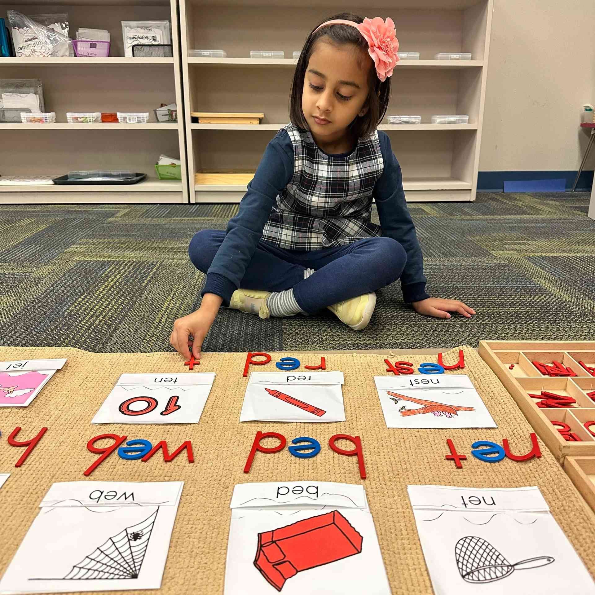 Child working with Montessori word building materials in Allen, TX
