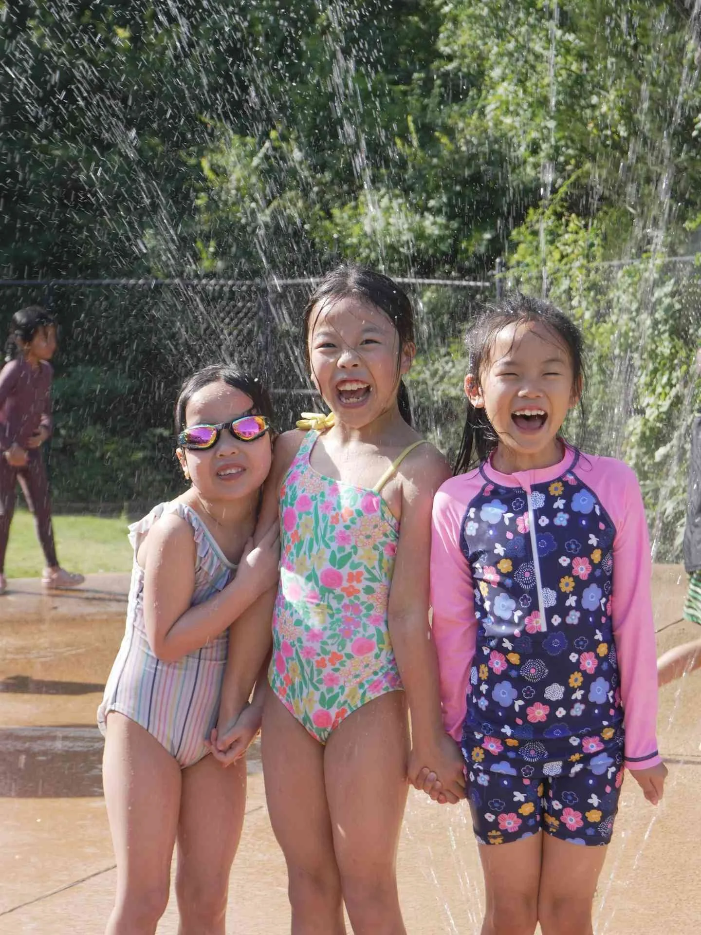 Children playing in a splash pad, enjoying summer enrichment, outdoor water activities in Allen, TX
