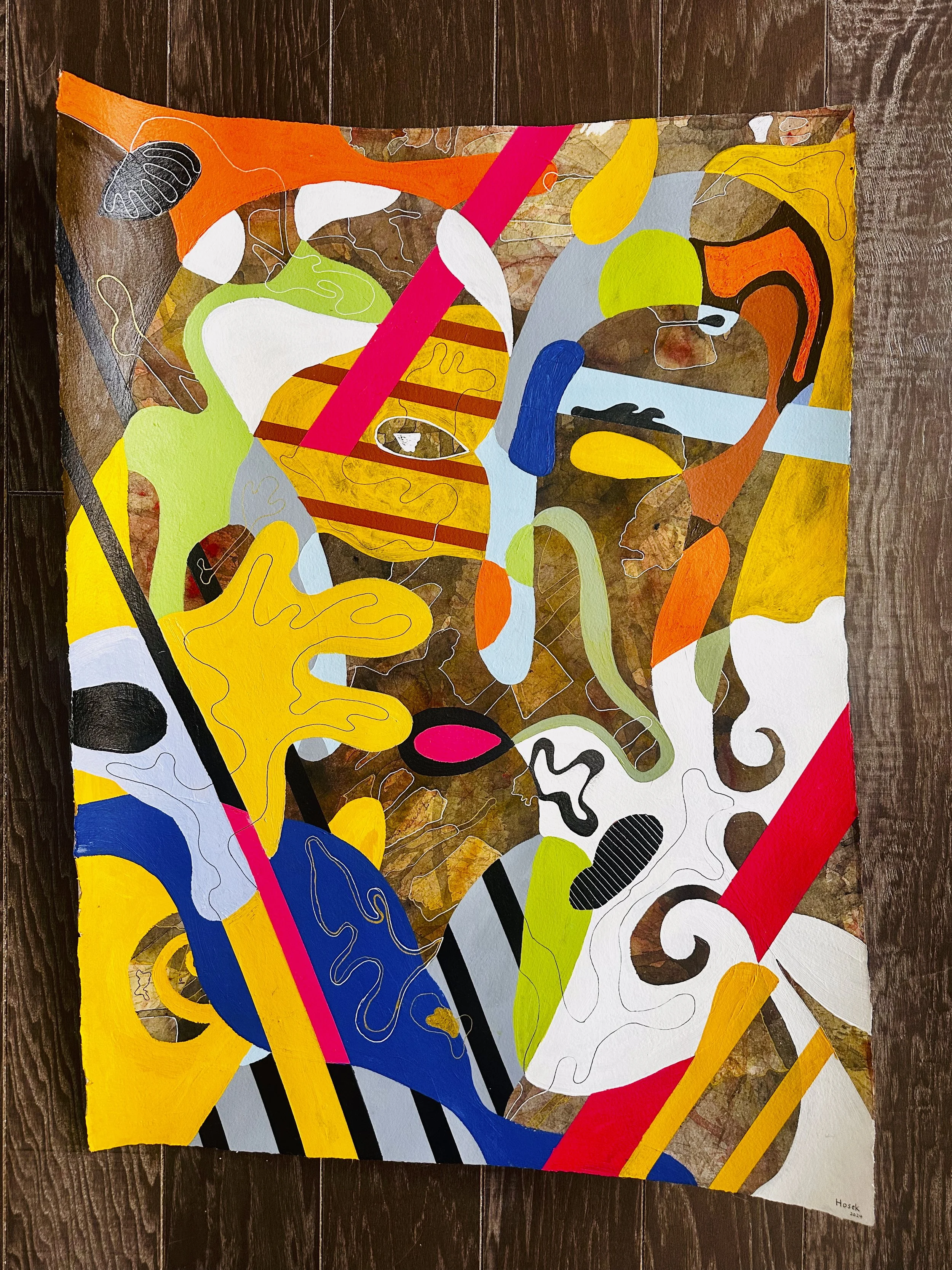 Colorful abstract painting with various shapes and lines, including bright yellow, red, blue, green, and black elements, on a brown textured background.