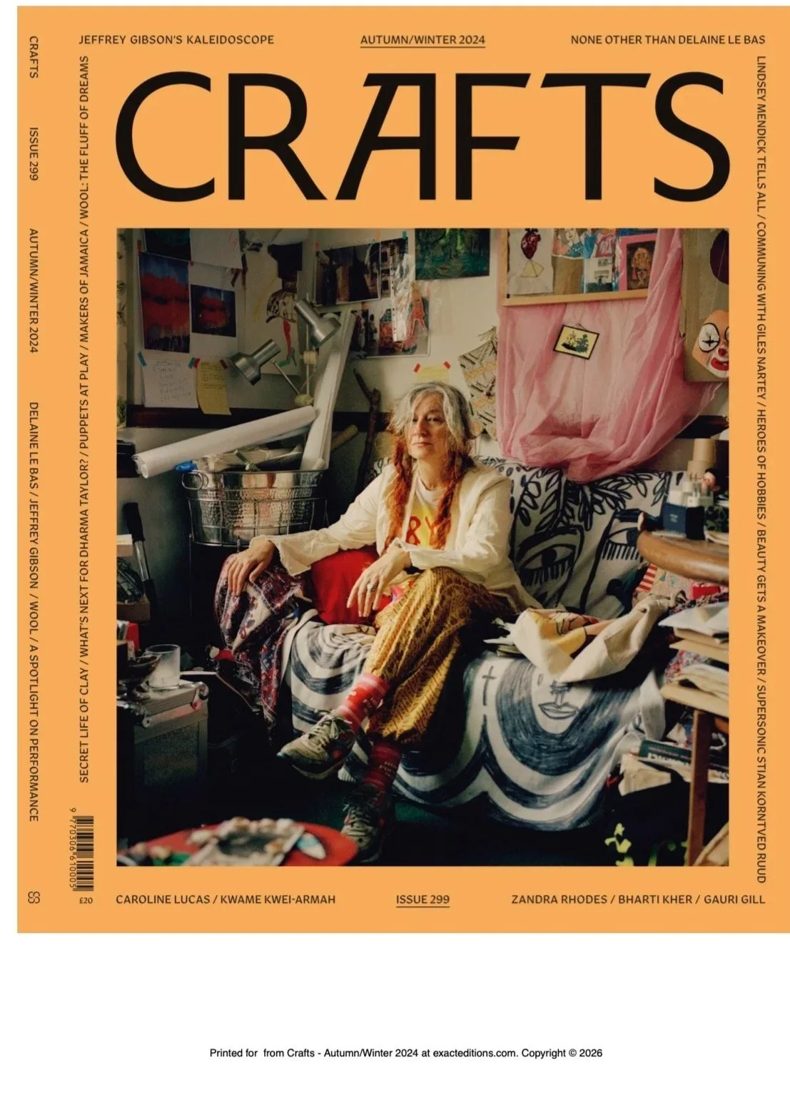 Cover of Crafts magazine, Autumn/Winter 2024 issue, featuring a woman with gray hair in a cluttered room filled with artwork and craft supplies, sitting on a bed with a colorful blanket.
