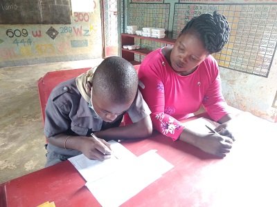 HHI Georgina Mwamsambo working assessing child April 12th 2022.jpg