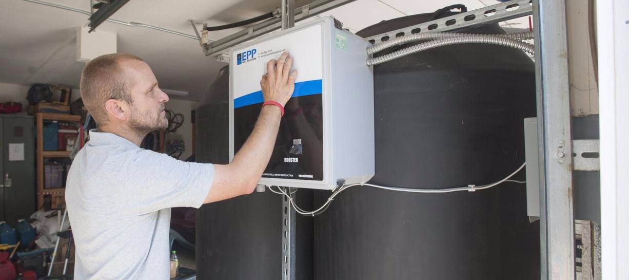 An Epp team member working with an earlier water-system controller