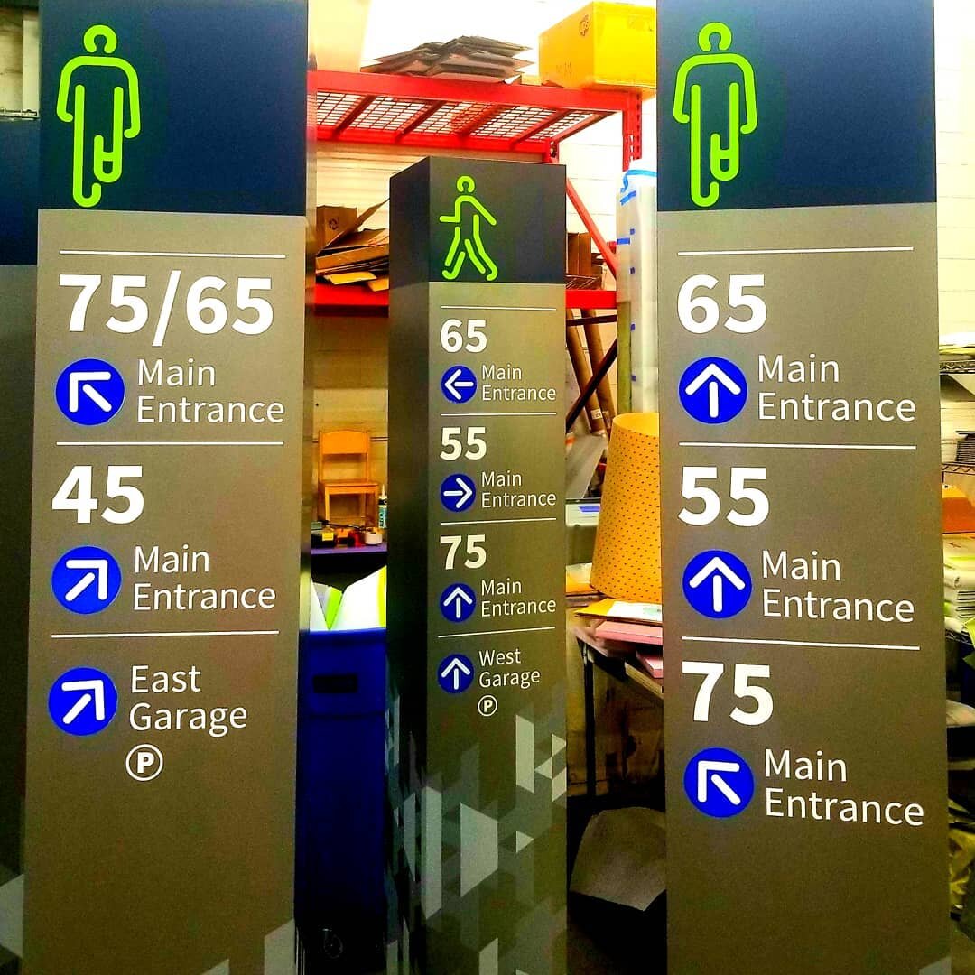 Here are some shop photos of campus wayfinding. They are 1ft-sq by 6ft tall of fabricated aluminum with applied digitally-printed graphic. #wayfinding #customsignage