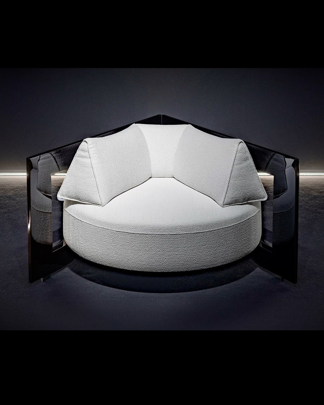 FRAME CHAIR

The structure becomes a boundary.

A solid frame surrounds the soft volume of the chair, creating a contrast between architectural precision and tactile comfort.

The polished wood reveals depth, reflection, and material presence, while 