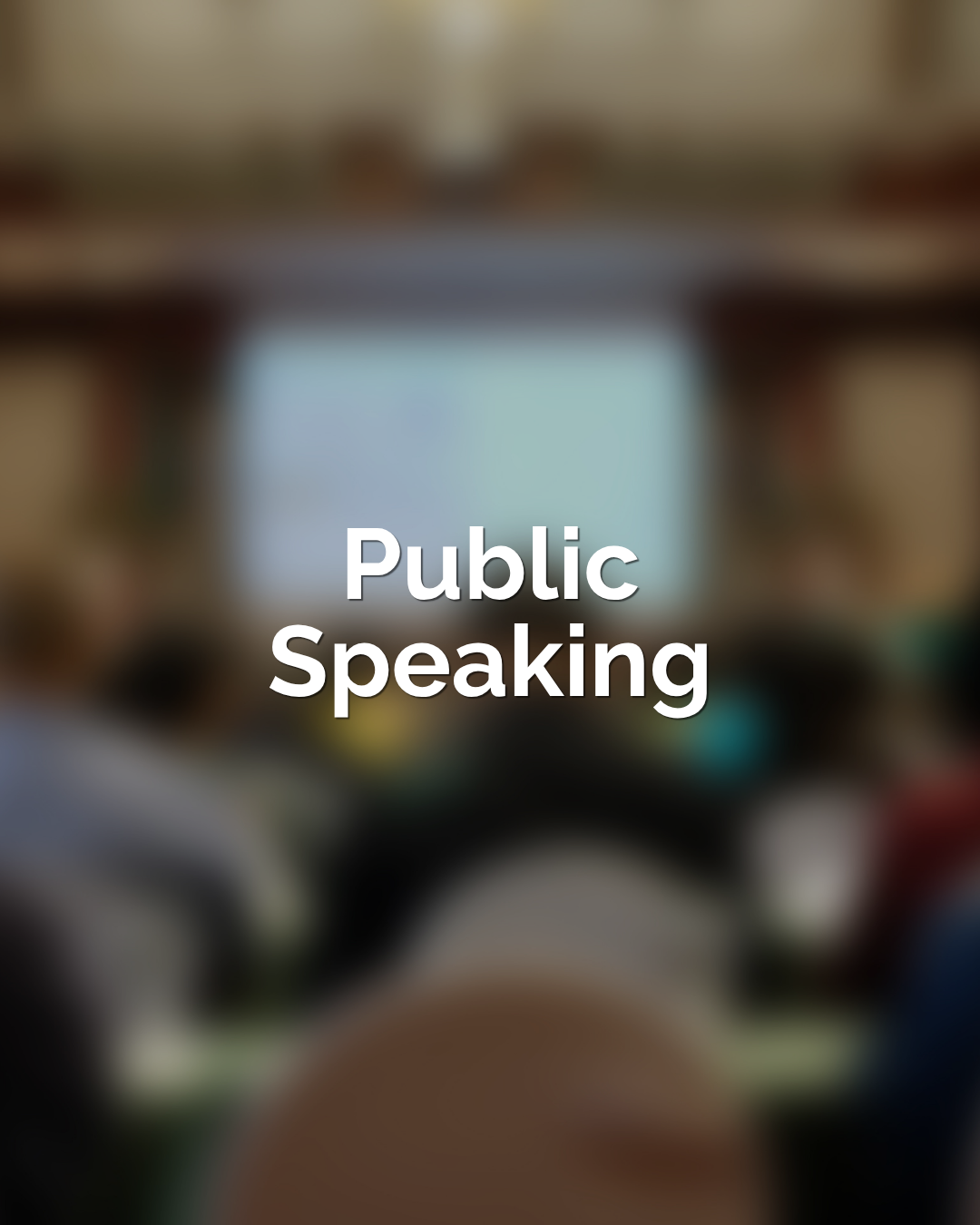 Kevin May speaking at a keynote conference presentation to a groupat a podium.