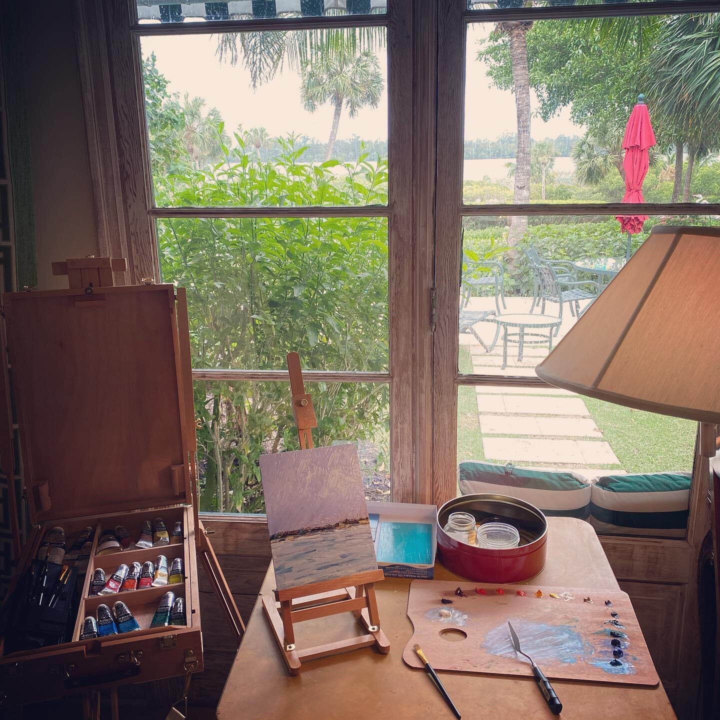 My quarantine studio is not so bad 😷🎨🌴☀️#sagegoldsmithpaintings #studio #oilpainting #canvas #ontheeasel #landscapepainting #inlet #water #trees #palmtrees #sunshine #florida #umbrella #paint #create #quarantine #staysafe #stayhome