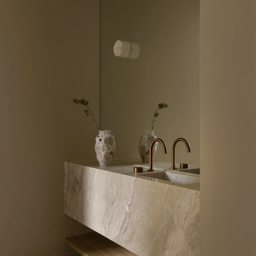 Project Alma - Bathroom
Honed natural stone with gentle movement, warm metal accents, and sculptural forms with organic character. Custom wall lighting intentionally selected for its minimal and softly diffused light. 
Architecturally designed and bu