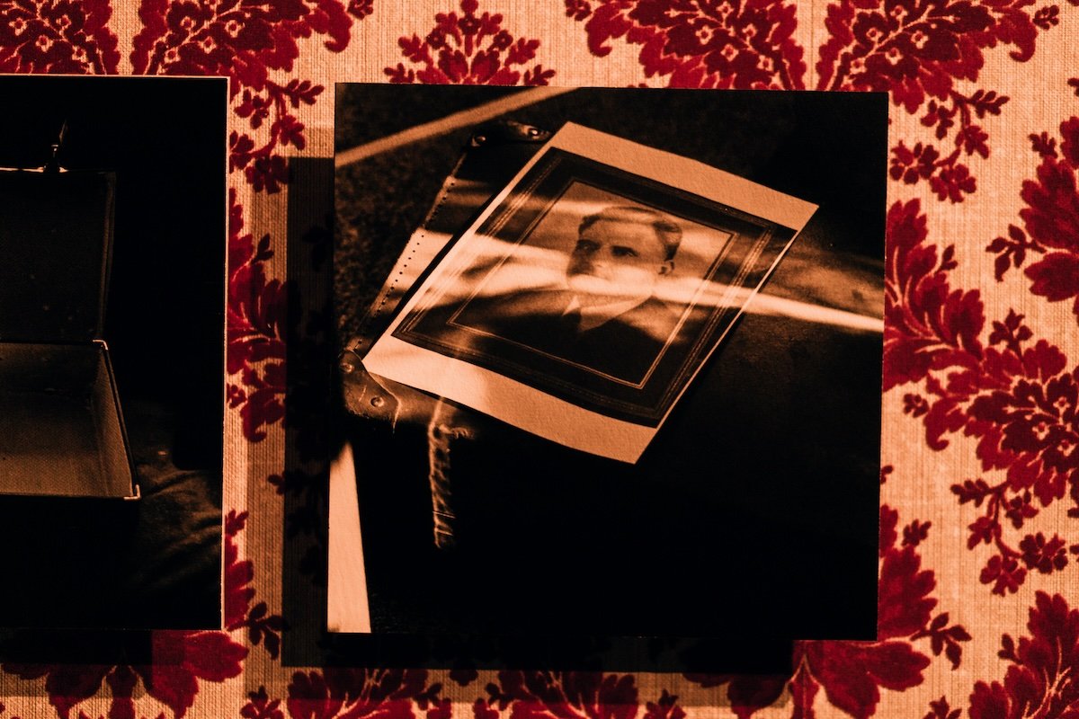 Alia Syed, 'A Suitcase Journey', 2025 (detail)
Digital photograph, 148 x 210mm matte print on 2mm board on 18mm wall mount on vintage red flock wallpaper
Nasreen Shahid’s Suitcase, from the 1930s belonging to her grandfather
holding a photograph of