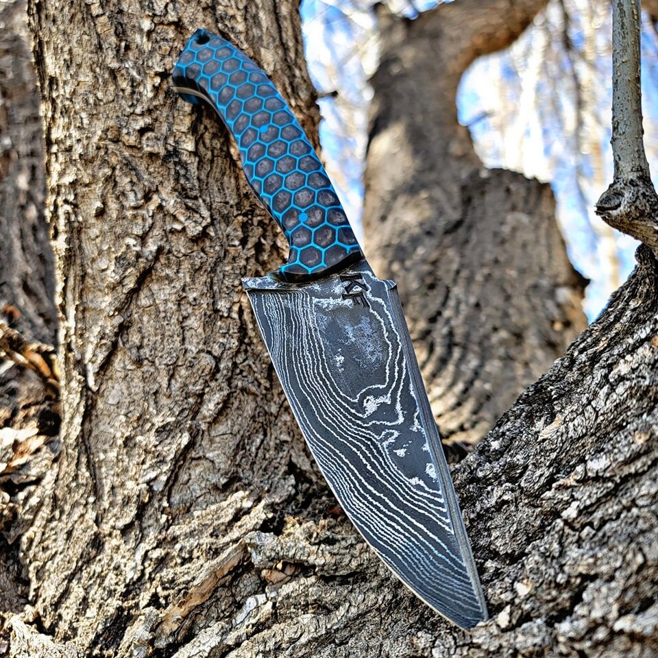 This beautiful random pattern Damascus EDC hunter! Tuen our great I love this style of knife and I have been trying to design one I really like and I think this might be the one! 

G10 honeycomb handle with epoxy. Blue g10 handle pins and a lanyard h