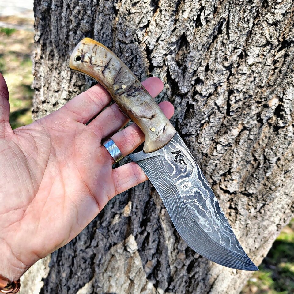 This killer random pattern Damascus skinner! 
Complete with ram horns handle and brass pins and lanyard hole.

This pattern turned out great of this knife! 
Let know what what you all thank! This one is available! 

And of course I do custom work. Th