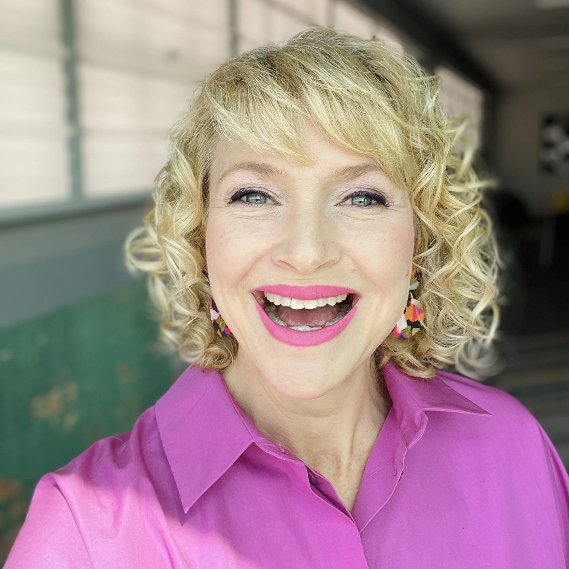 Laura Beauparlant showcasing her personal brand, wearing signature style and natural curls, reflecting her business identity and values.