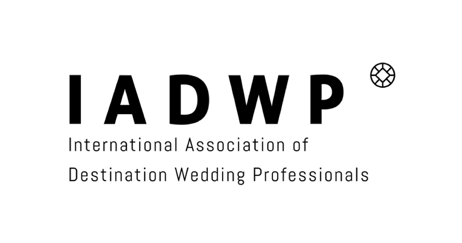 Logo of the International Association of Destination Wedding Professionals (IADWP) with text and a small circular emblem.