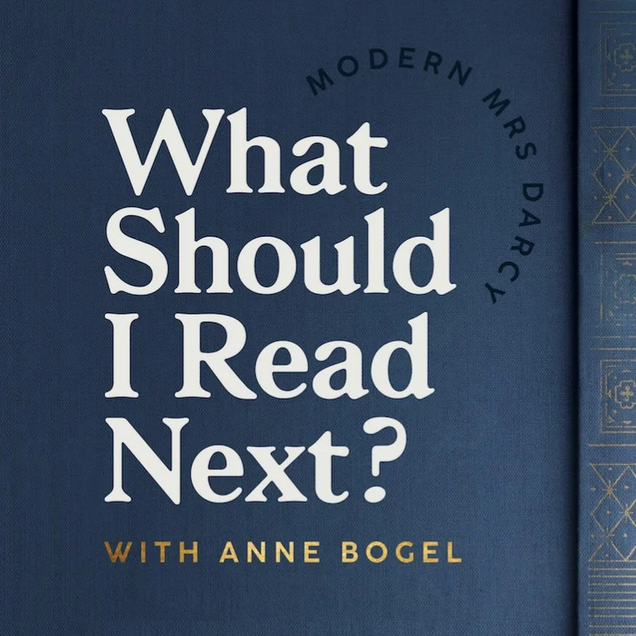 'What Should I Read Next?' podcast show art. Hosted by Anne Bogel, with a dark blue background and decorative gold and black detailing.