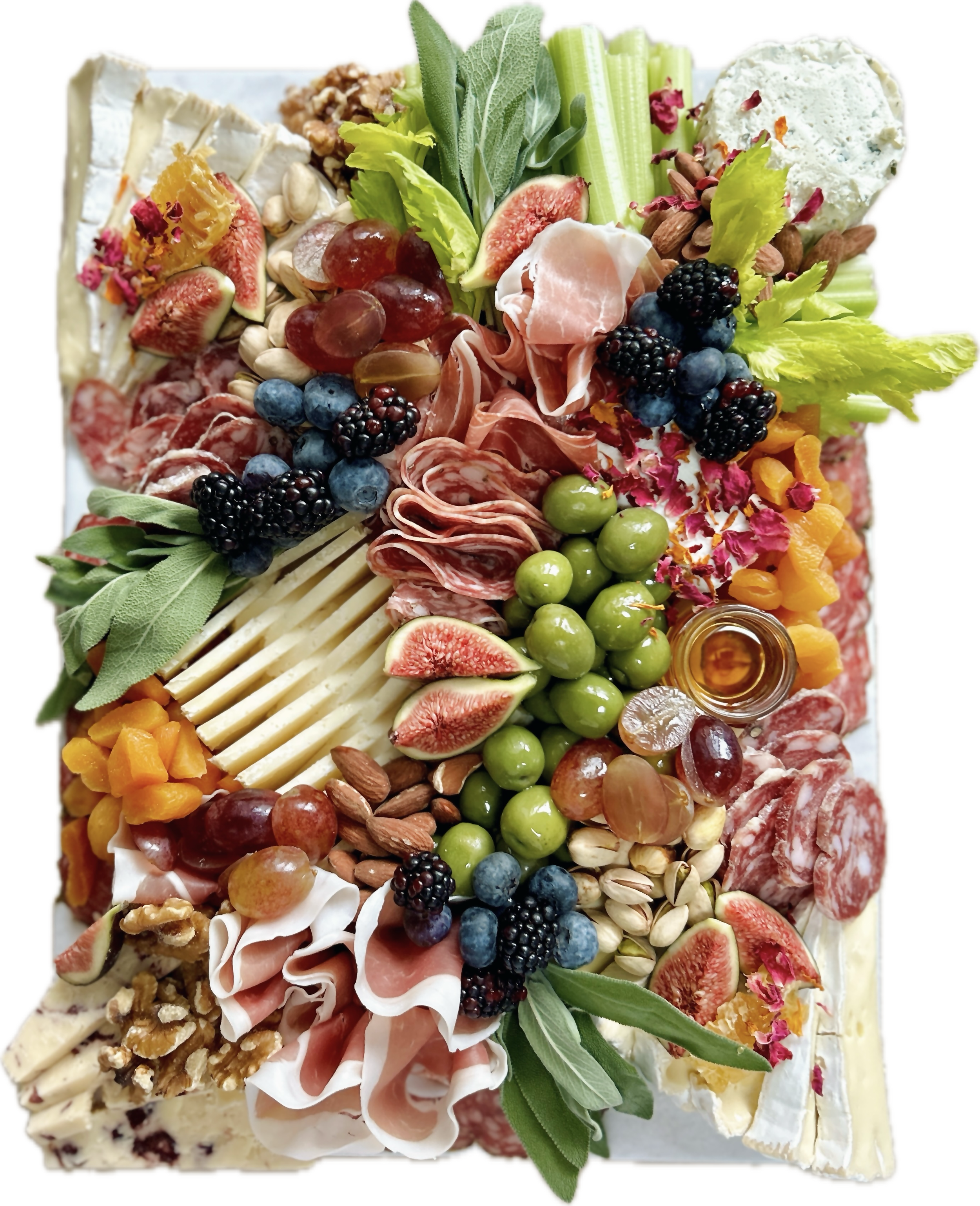 A cheese and charcuterie board with various cheeses, meats, fruits, nuts, and honey.