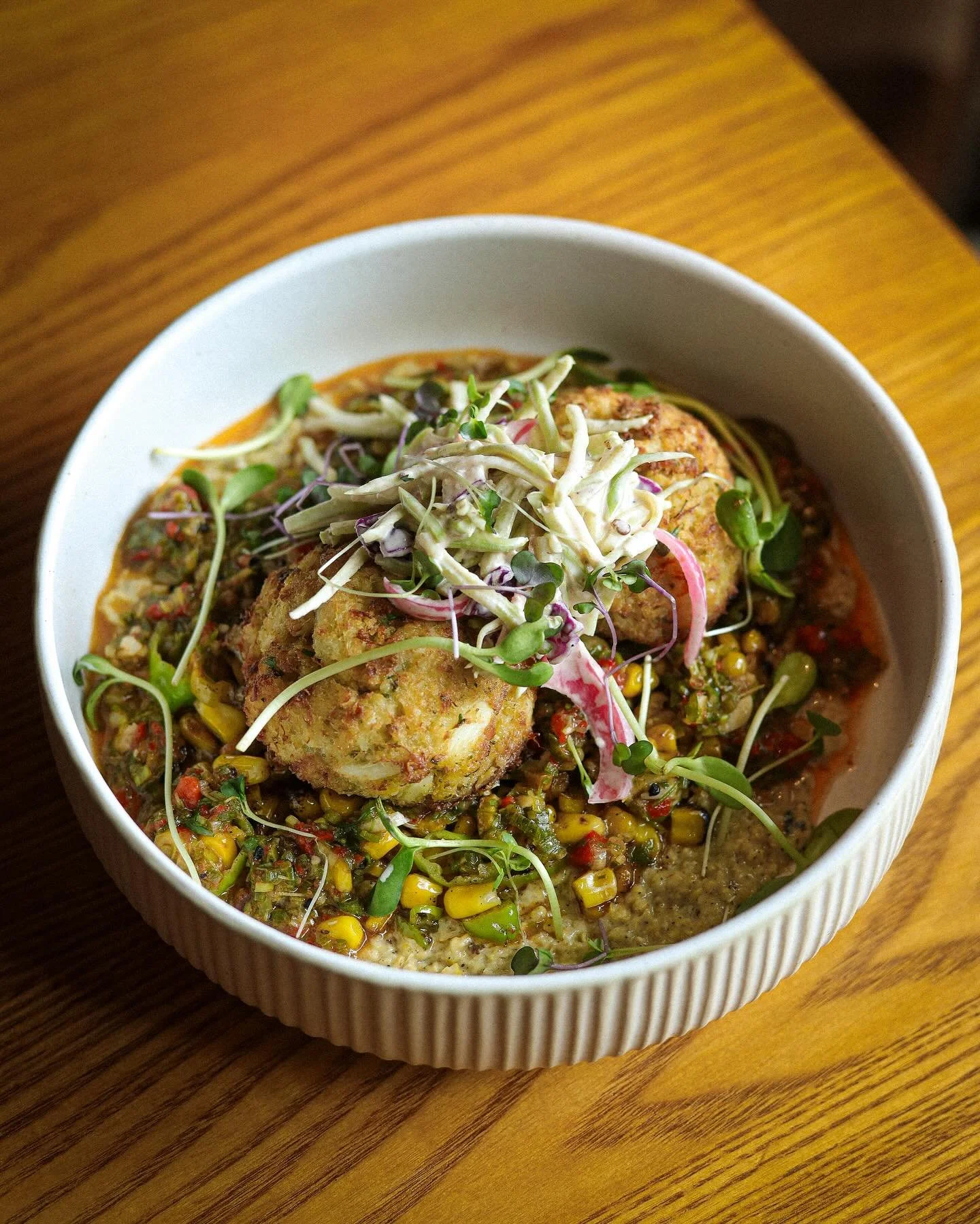 Roasted Lump Crab Cakes 🦀 

Roasted Corn Pur&eacute;e, Blistered Corn, Shishito Peppers, Green Goddess Slaw, Red Pepper Chimichurri. 

Available on the dinner menu!