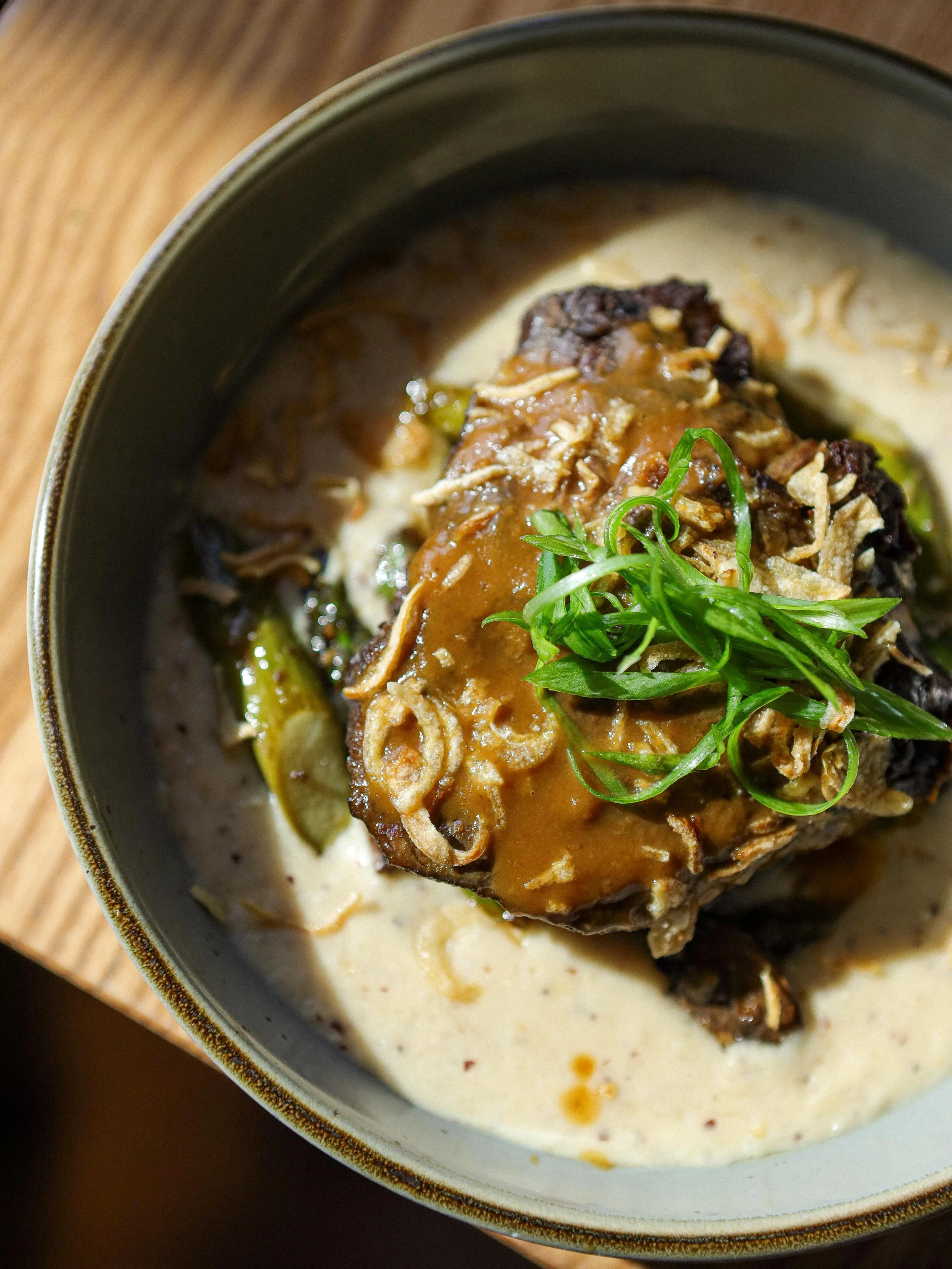 Red Wine Braised Beef Cheek 🍷 

Smoked Cheddar Grits, Roasted Mushrooms &amp; Asparagus, Crispy Onions, Spring Onion Garlic Butter.

Available on dinner menu (OpenTable link in bio).