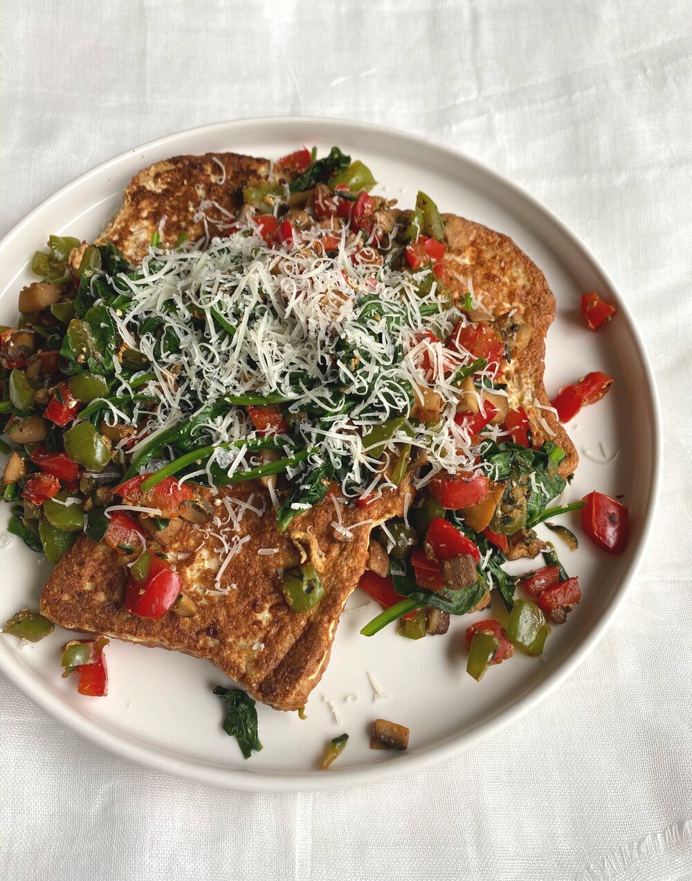  savory french toast with sautéed spinach, mushrooms, bell peppers, &amp; zucchini and grated parmesan 