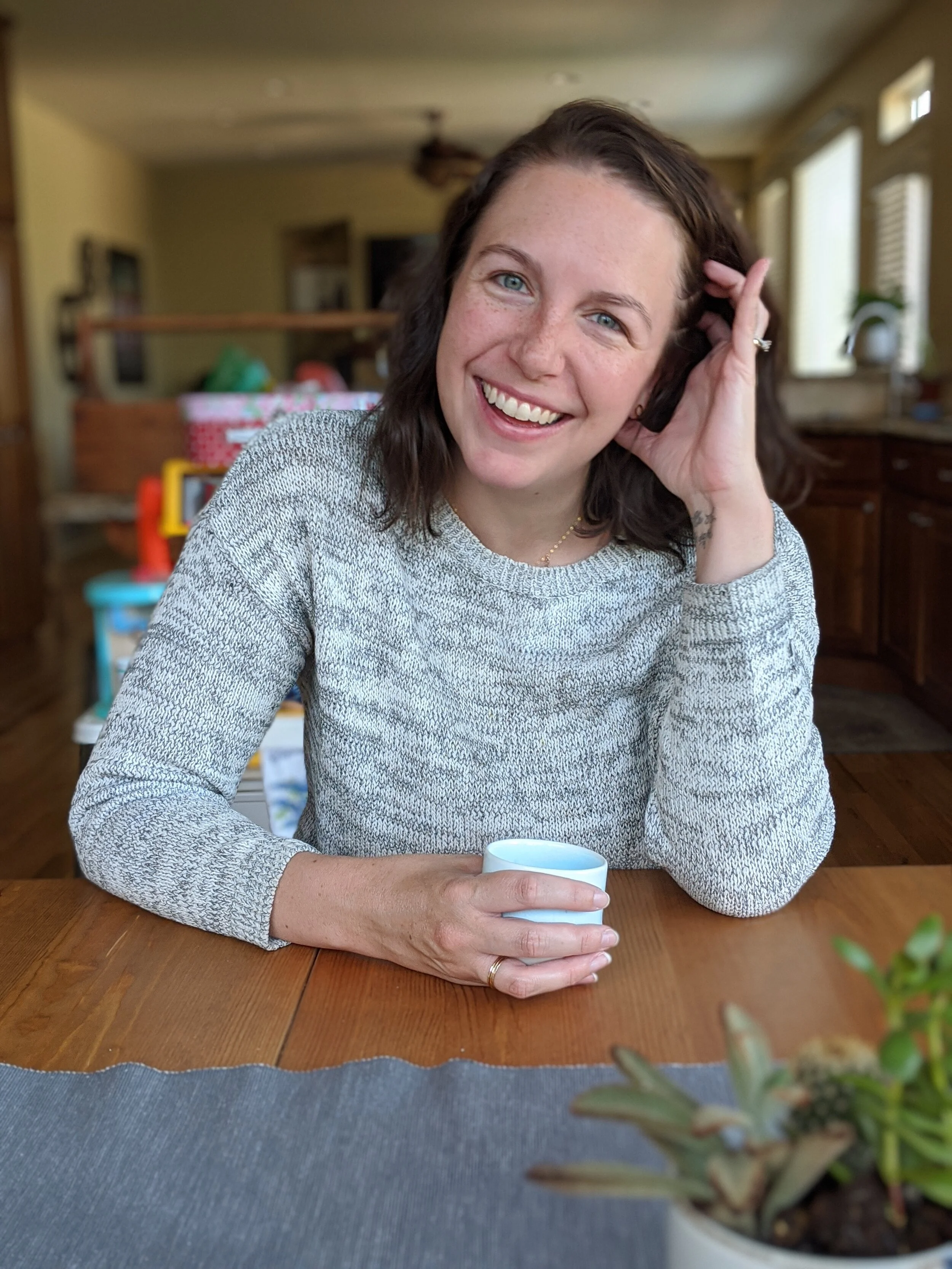 life coach drinking coffee smiling with ease