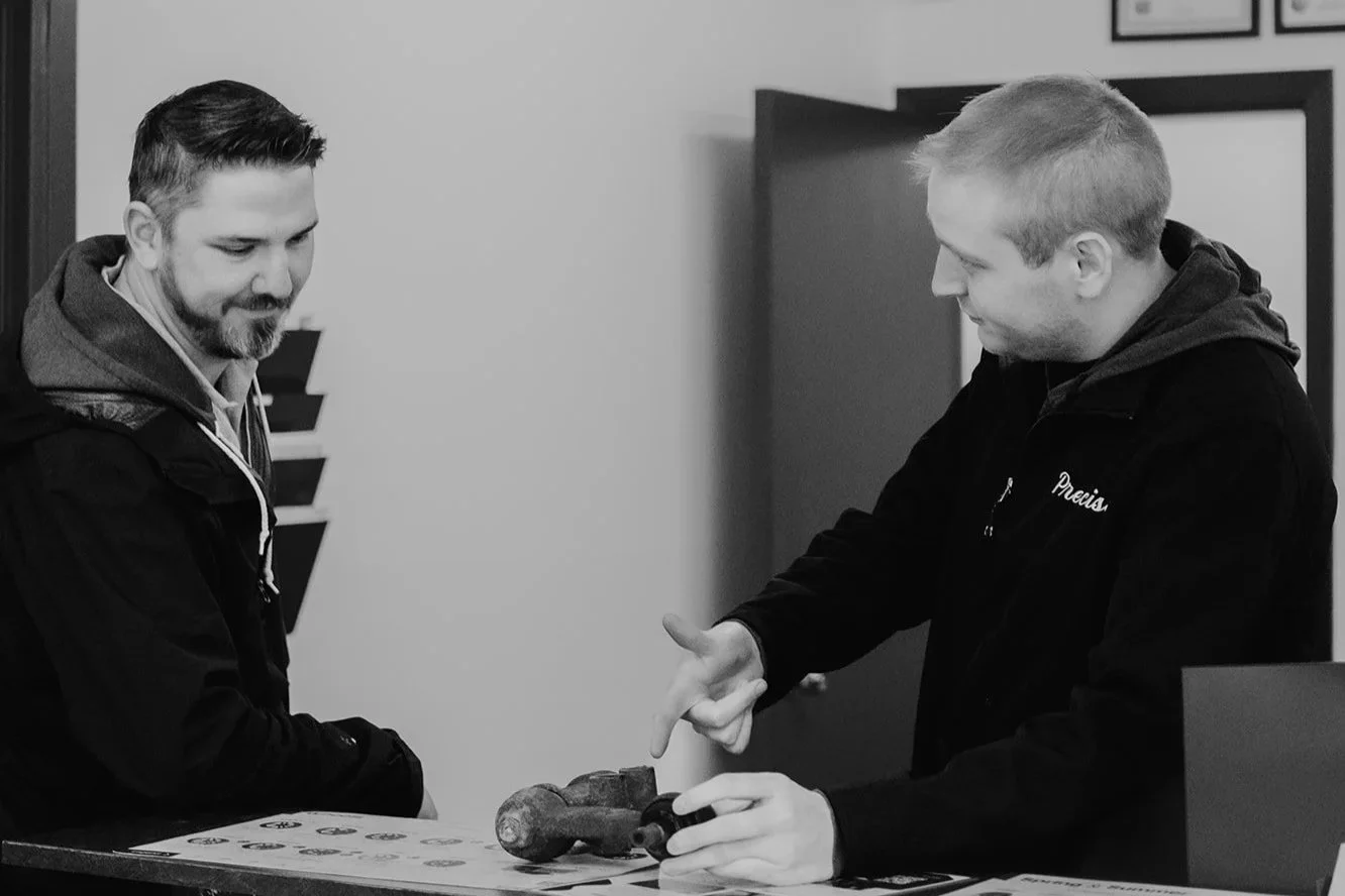 Vehicle service advisor speaking with client