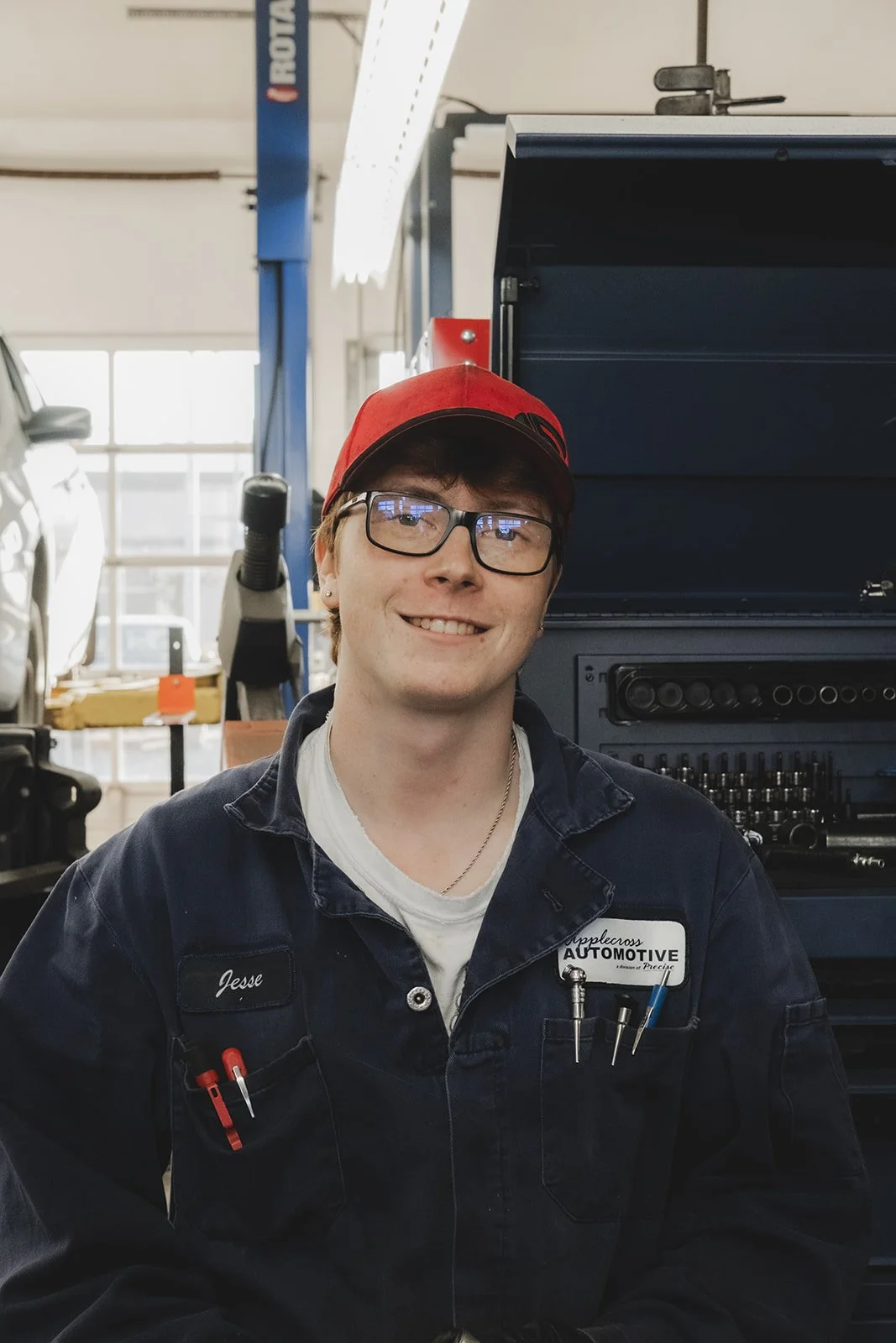 Man with red cap in automotive shop