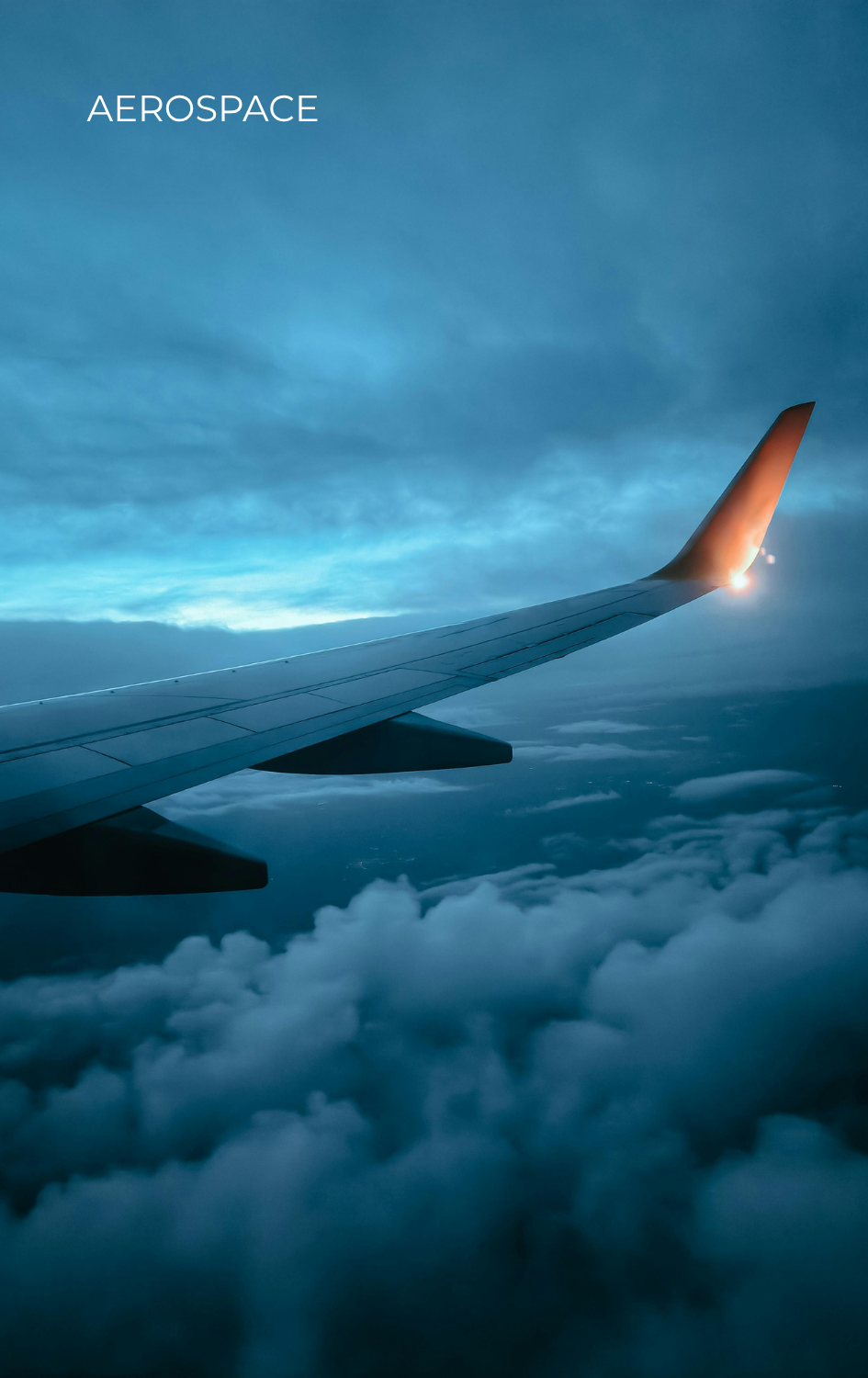 View from an airplane window showing airline wing with clouds below and evening sky, with text 'AEROSPACE'.