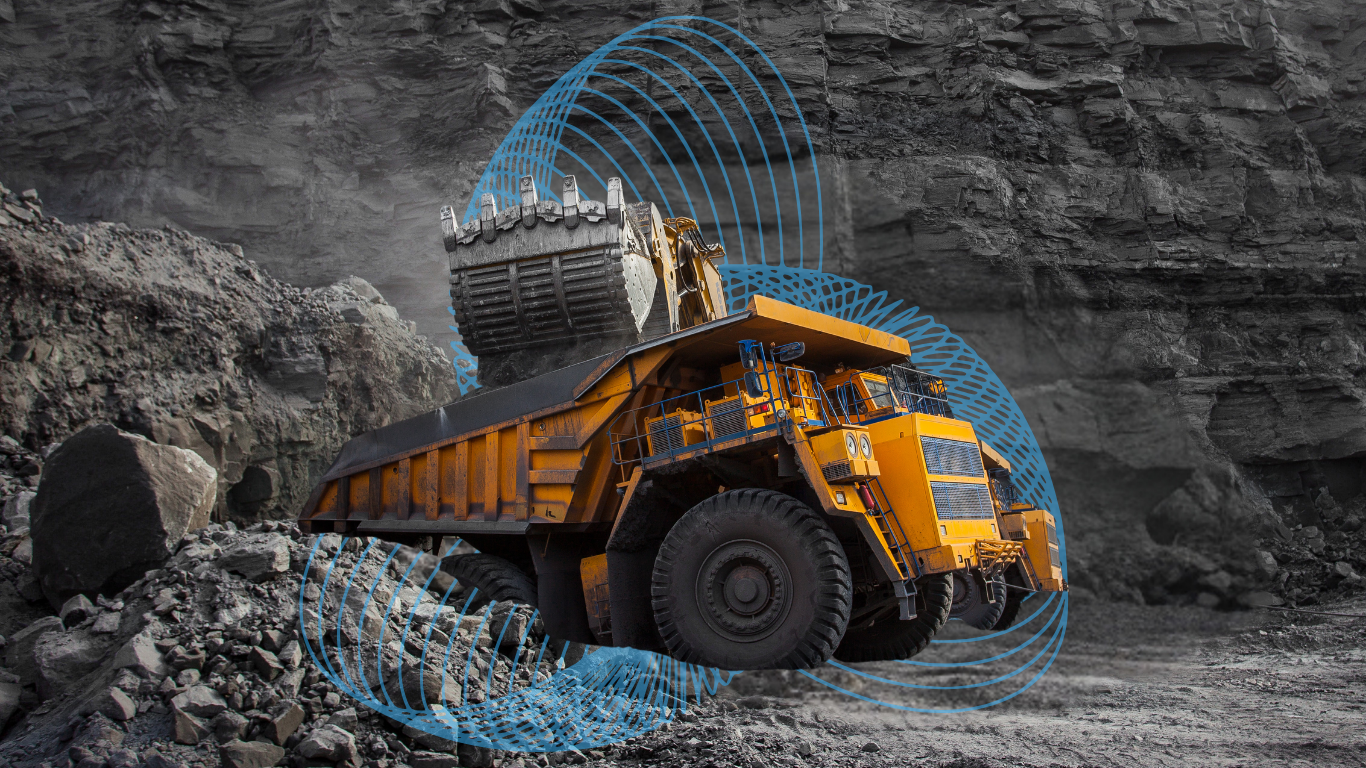 A large yellow construction dump truck operating in a rock quarry with digital blue overlay patterns indicating sensors or data.