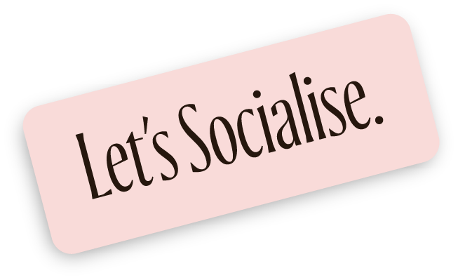 Pink sign with black border says "Let's Socialise" in black text.