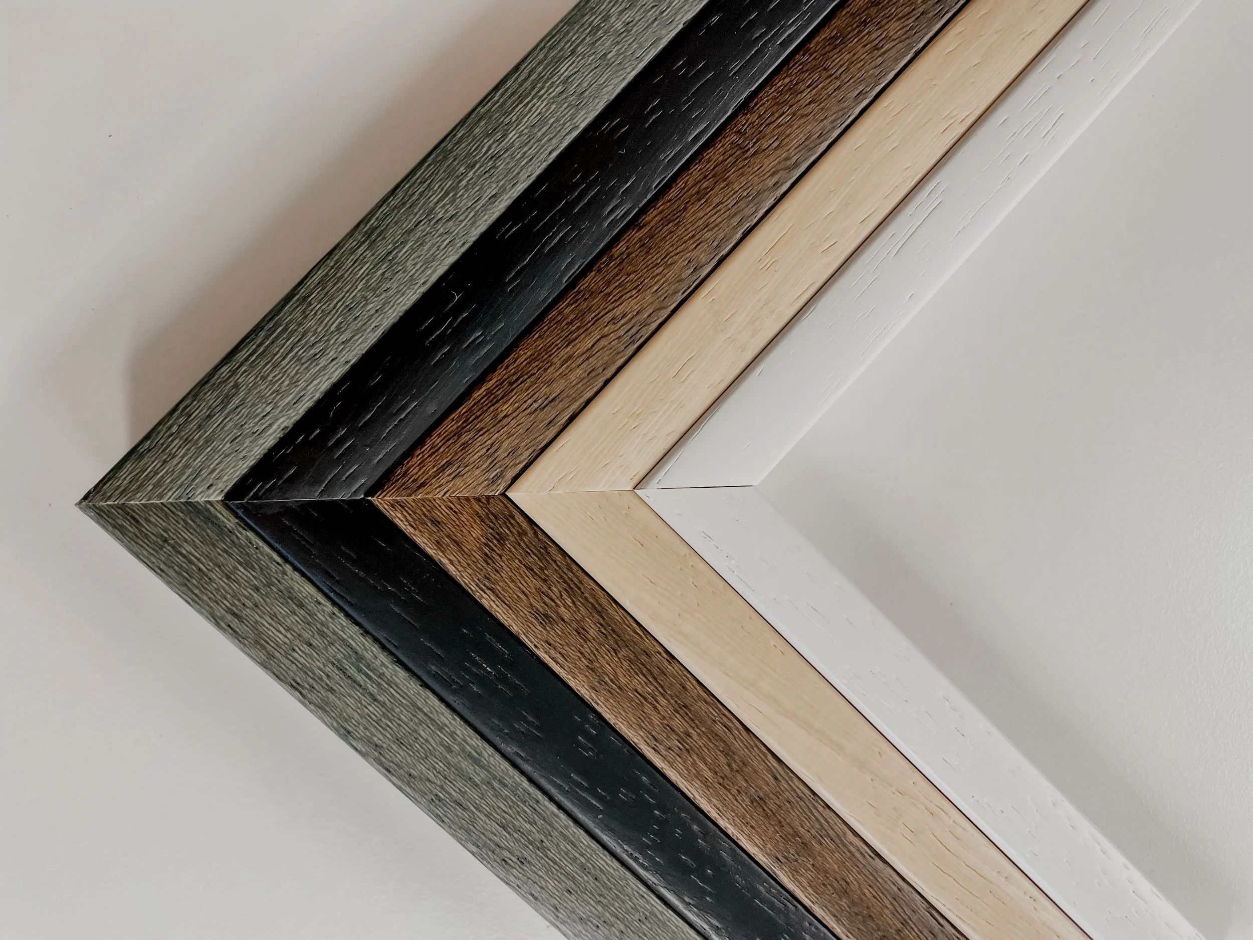 Close-up of corner molding with multiple wood finish colors arranged in diagonal layers