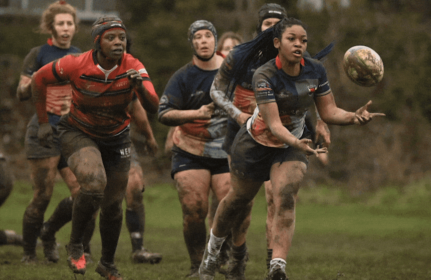 Hackney Ladies RFC player on a muddy pitch during a women's rugby match in London