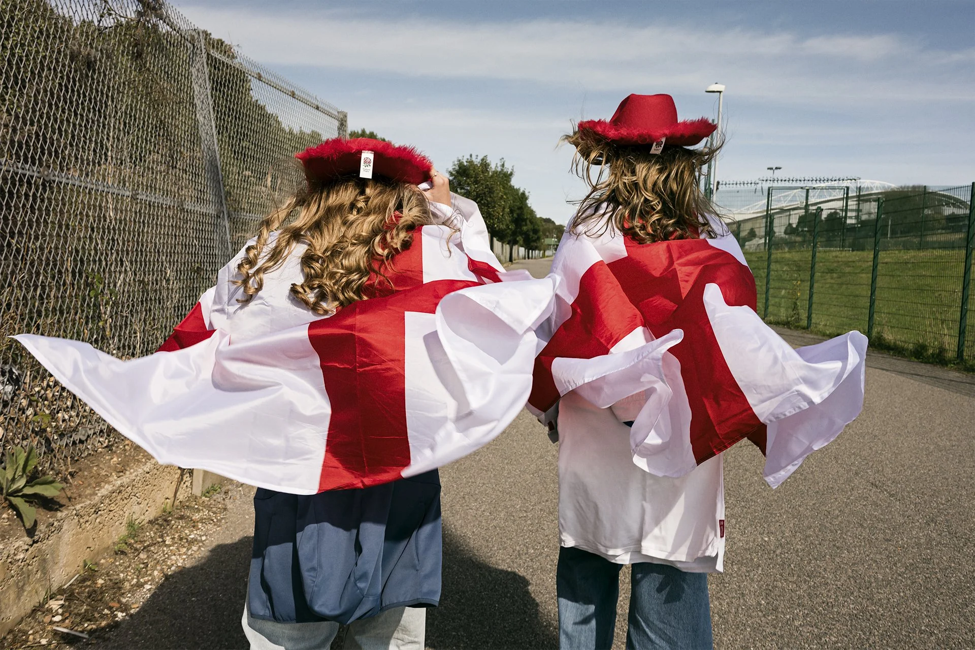 England supporters in flags and rose hats walk to the ground, Women's Rugby World Cup 2025, Brighton, by Karen Yeomans