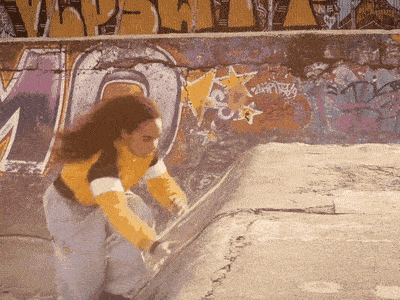 Georgia Munroe rolling out of a parkour move on a concrete ledge, from the parkour short film