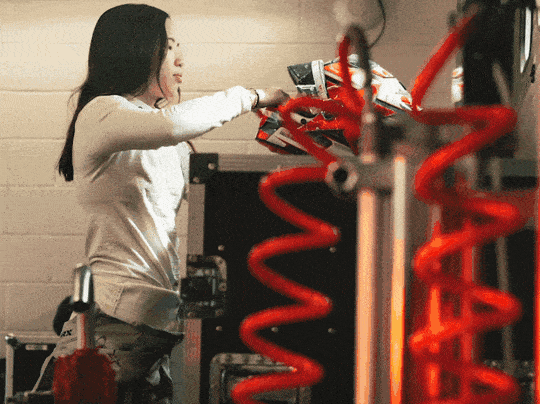 Female racing driver post race removing her helmet