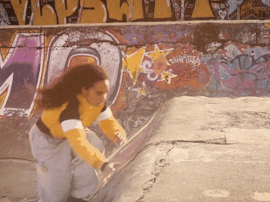 Georgia Munroe rolling out of a parkour move on a concrete ledge, from the parkour short film