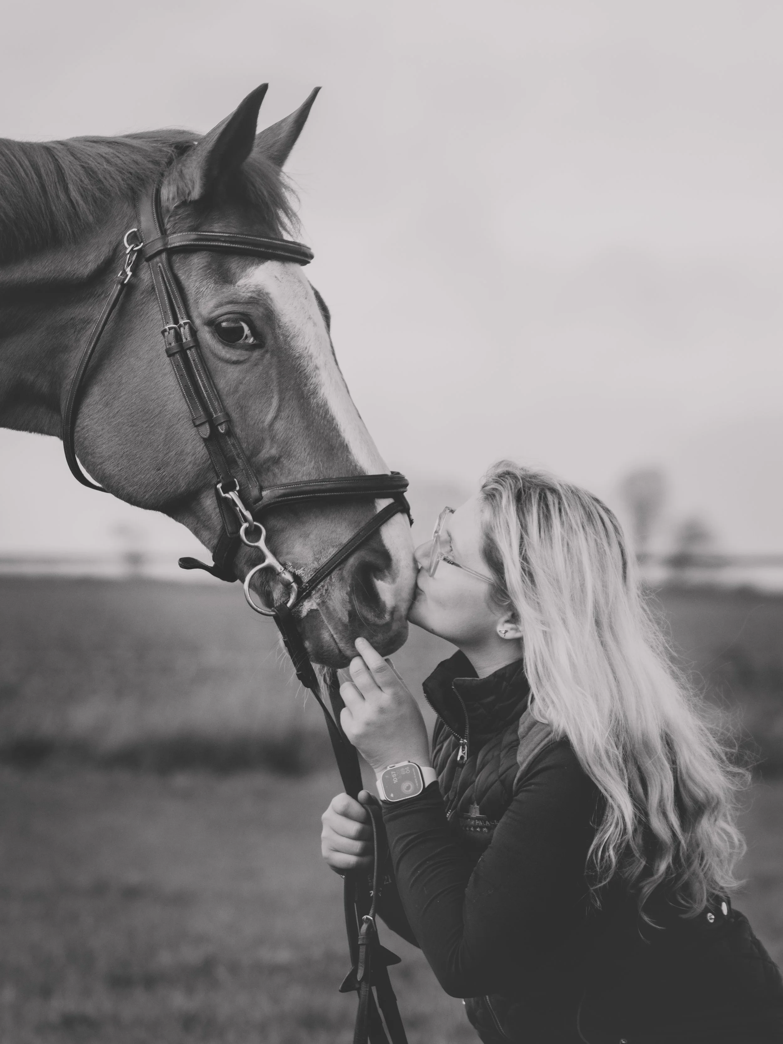 black and white equestrian portrait owner kissing nose