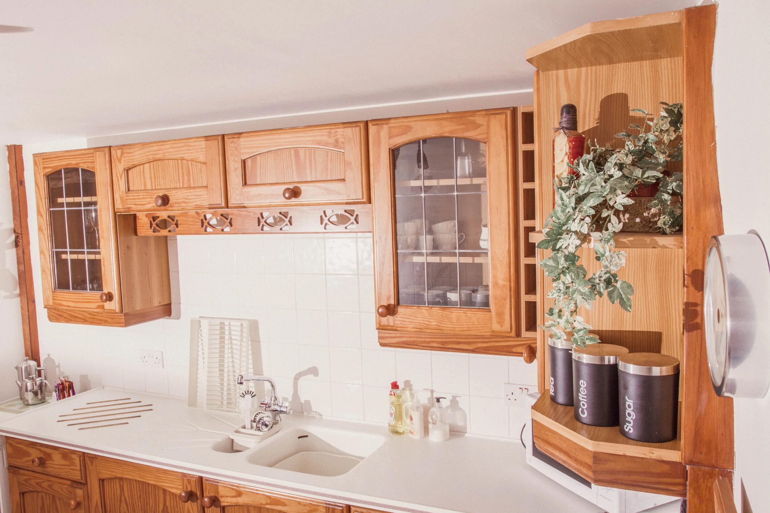 Open-plan kitchen space with fridge/freezer, cutlery, crockery, electric oven, kettle and microwave 