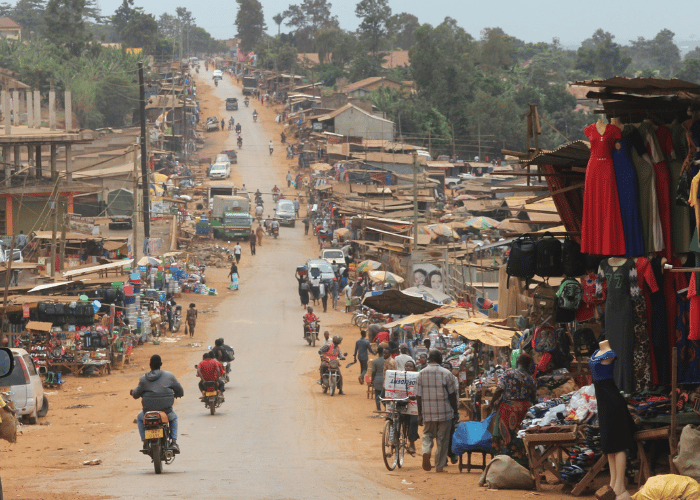 Rural road with motorbikes and small village lining it