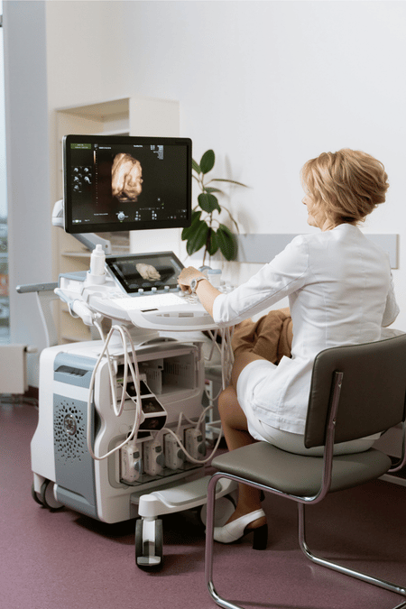 Woman doctor looking at an ultrasound machine