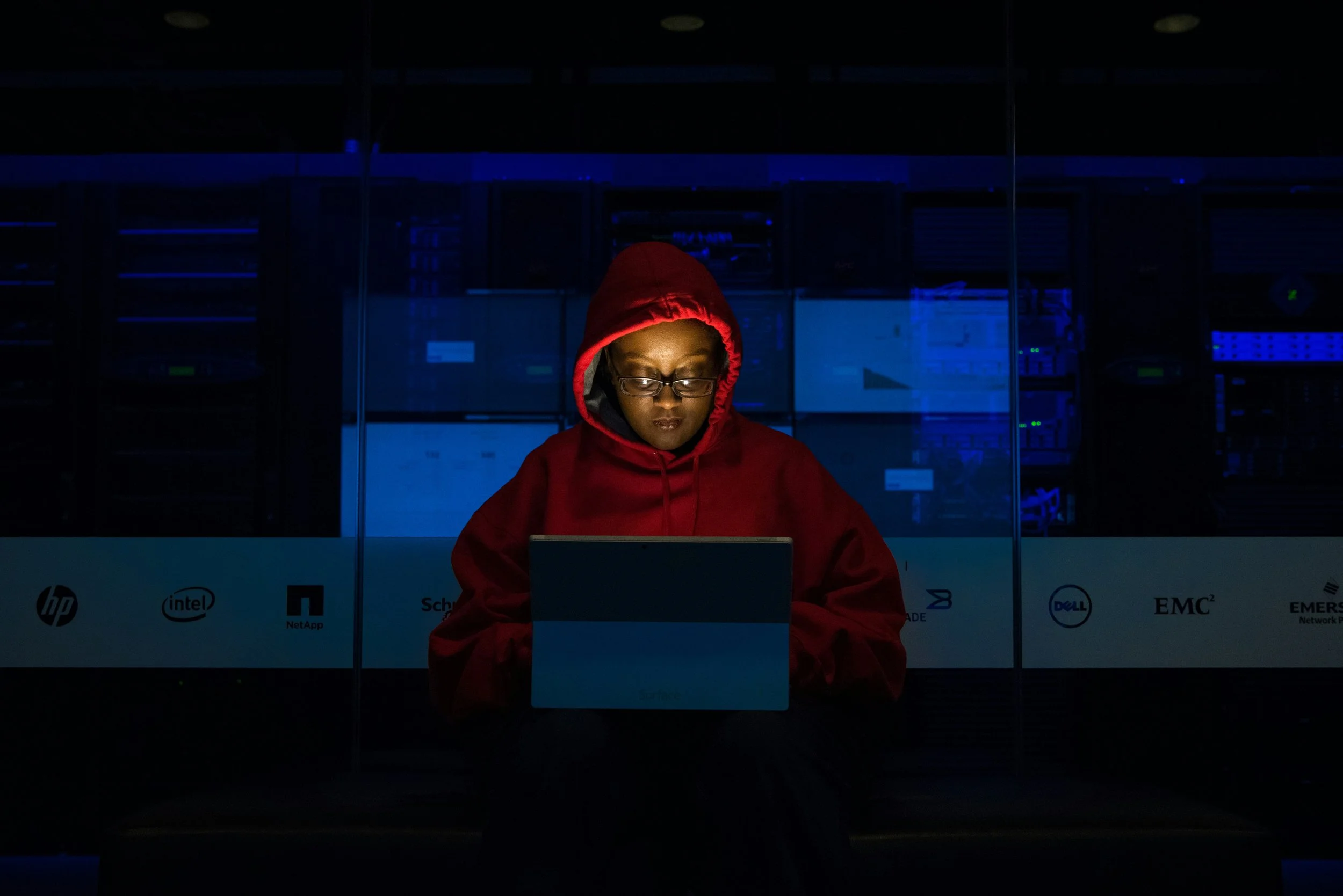 Dark photo of woman on computer in dark room
