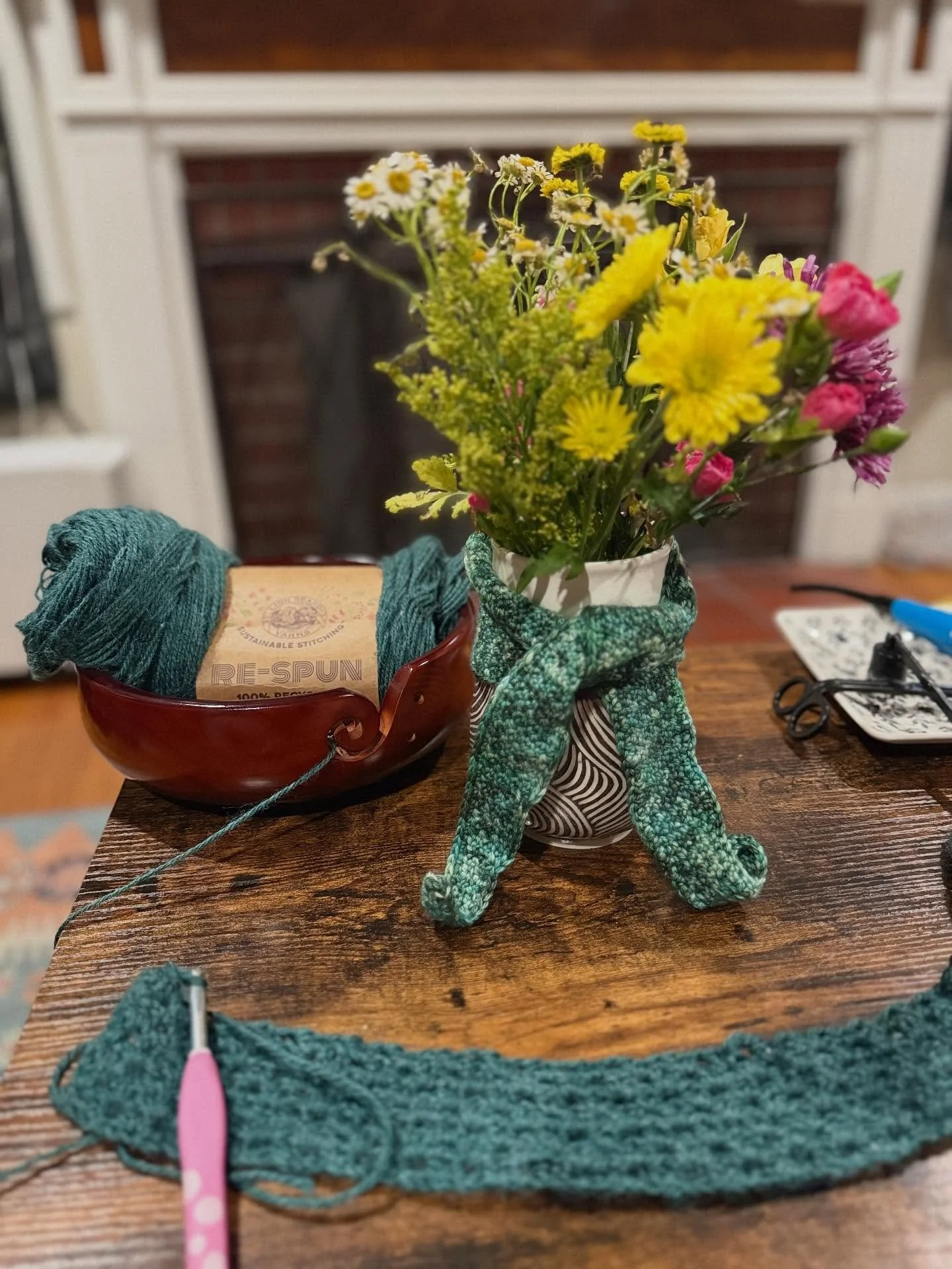 Clearly hooked on crochet 🧶 

Finished my first project for the #crochetacademy2025 CAL and promptly cast on a new project!!

Project 1 (on the vase): #BernieScarfTrio - Kerchief using Ocean Green by @littlefiberco 

Project 2: #ToniCuffedCardi usin
