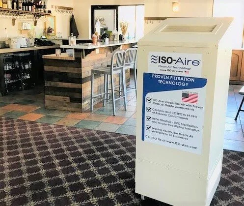 ISO-Aire HEPA air purifier in the foreground of a restaurant