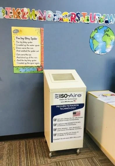An ISO-Aire HEPA purifier placed along a wall of a classroom