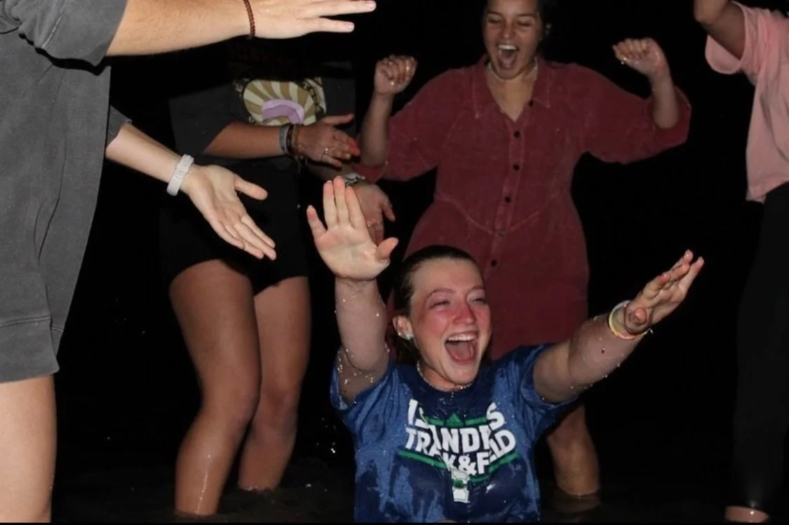 A Delight girl coming out of the water during a baptism.