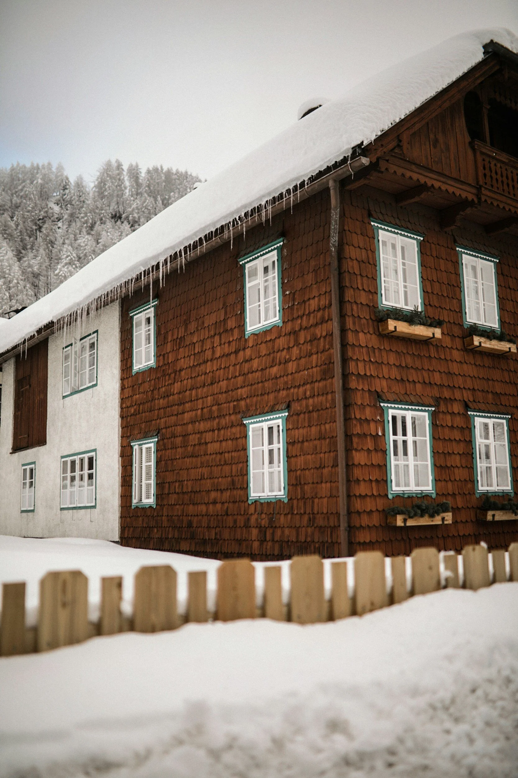 Snow-covered building in winter, emphasizing the challenges faced by displaced populations during extreme weather and the need for reliable lodging solutions provided by Lima Charlie Inc.