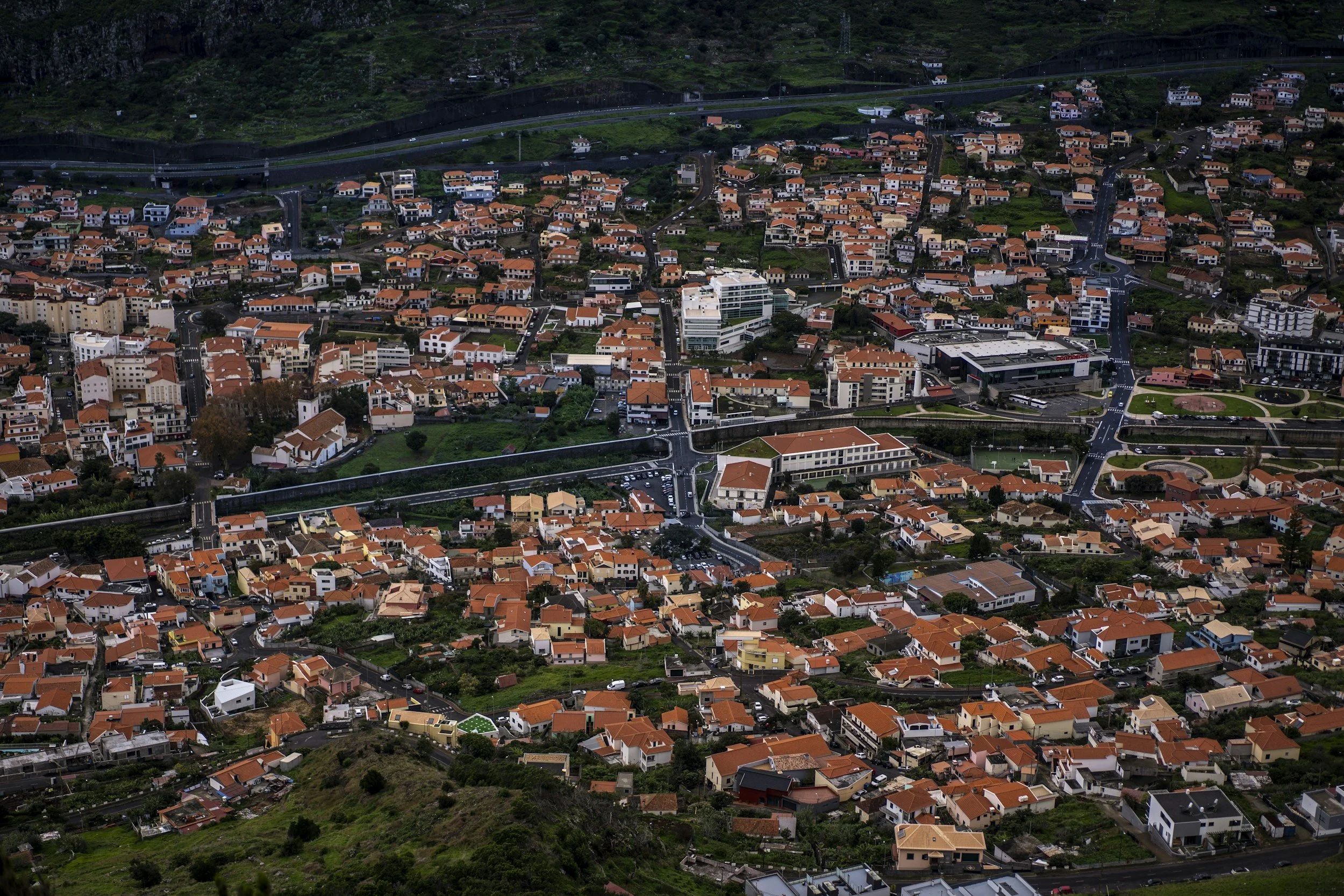 Aerial view of a densely built city with mixed residential properties, symbolizing the geographic diversity and regional scalability required for agencies and corporate teams building lodging networks with Lima Charlie Inc.