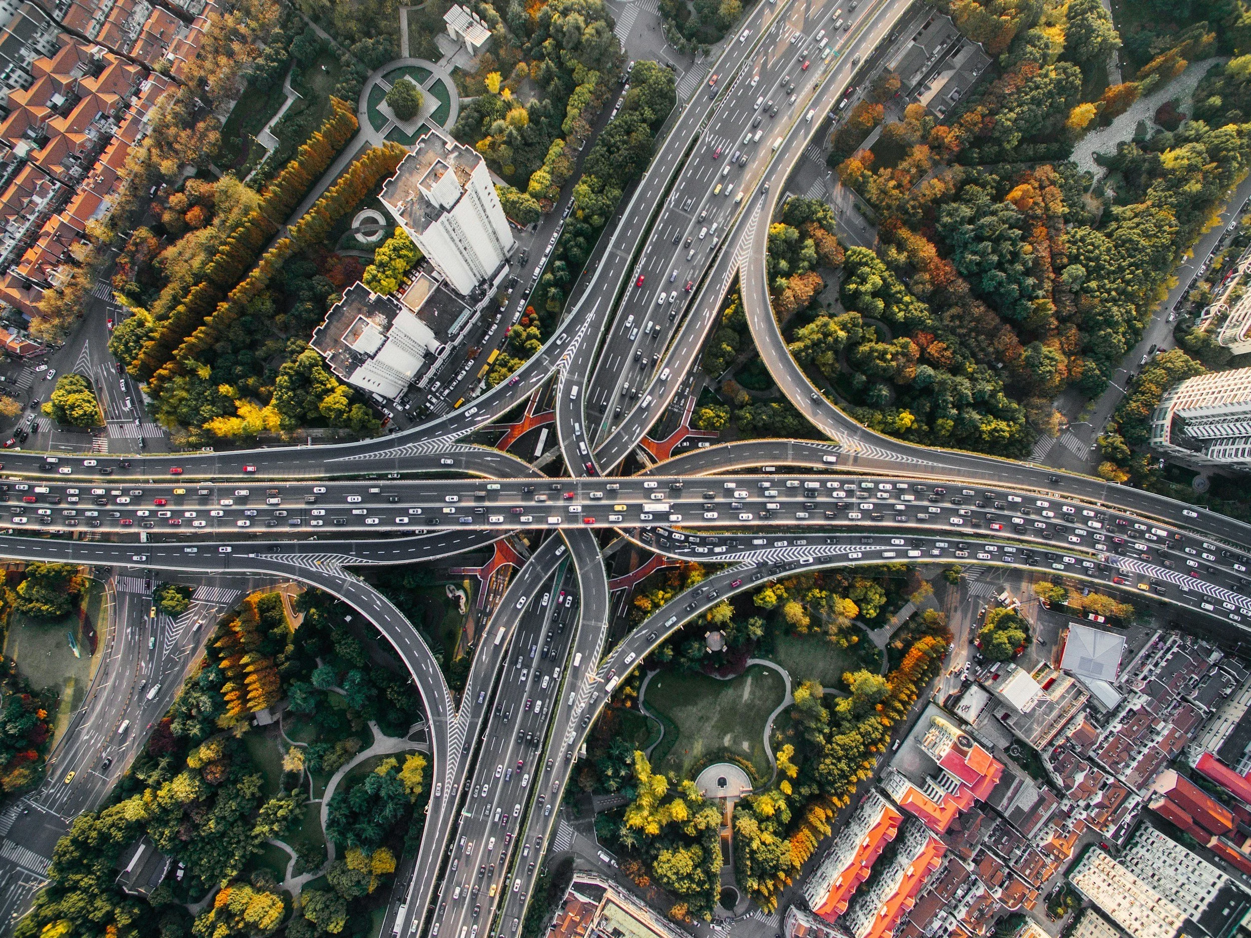Aerial view of a complex highway interchange representing centralized coordination and multi-city workforce housing logistics managed by Lima Charlie Inc.
