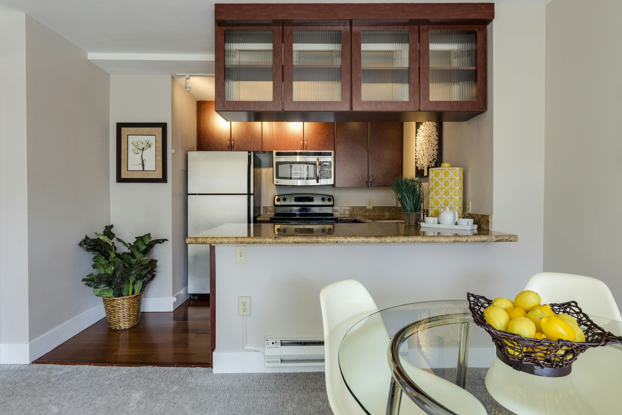 A fully furnished kitchen with granite countertops and a dining table, the move-in ready housing Lima Charlie Inc. prices to current BAH and JTR guidelines.