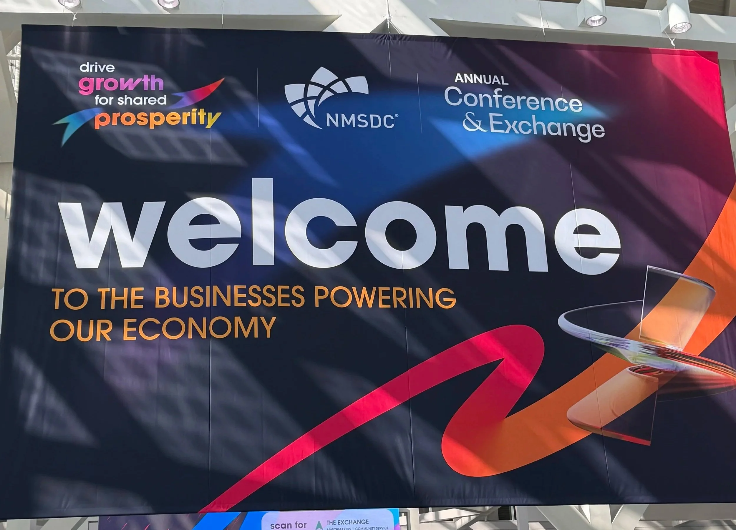 A large banner at the NMSDC Annual Conference and Exchange reading welcome to the businesses powering our economy, where Lima Charlie Inc. met supplier diversity teams.