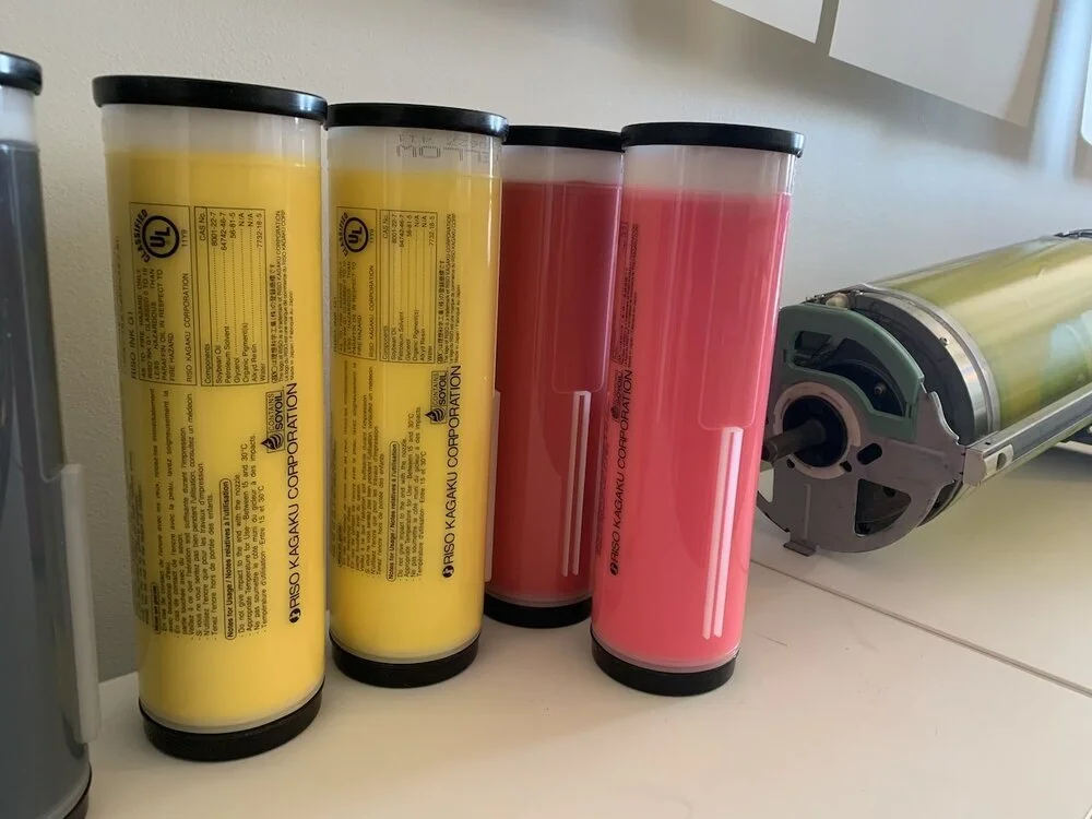  Riso ink drums (yellow, red, and fluorescent pink) 